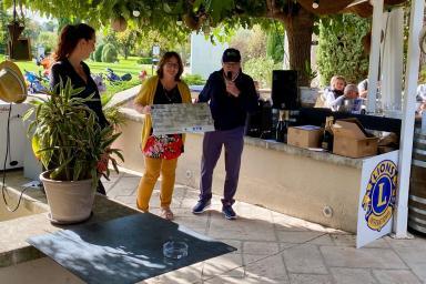 Photo de 3 personnes en train de porter un chèque