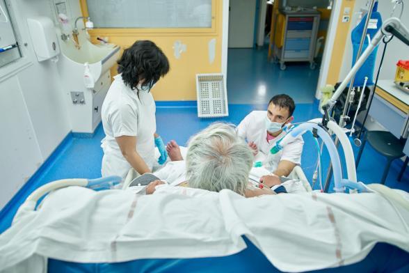 Deux soignants s'occupent d'un patient - Agrandir l'image, fenêtre modale